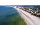 Aerial view of beach, ocean, and coastal homes at 3505 Casablanca Ave, St Pete Beach, FL 33706