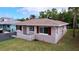 Cute bungalow style home with a low-pitched roof and burgundy shutters at 3505 Casablanca Ave, St Pete Beach, FL 33706