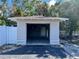Exterior view of the detached garage with an open door, offering convenient parking and storage space at 3505 Casablanca Ave, St Pete Beach, FL 33706