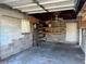 Inside the detached garage, which offers convenient shelving, lighting, and an open design for storage solutions at 3505 Casablanca Ave, St Pete Beach, FL 33706