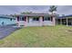 One-story home with maroon shutters and a manicured lawn at 3505 Casablanca Ave, St Pete Beach, FL 33706