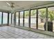 Bright sunroom with tiled floor and view of backyard at 3505 Casablanca Ave, St Pete Beach, FL 33706