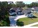 Modern white house with gray roof and a two-car garage, nicely landscaped at 4675 Hickory Oak Dr, Brooksville, FL 34601