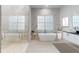 Elegant bathroom featuring a soaking tub, walk-in shower, and marble finishes at 4675 Hickory Oak Dr, Brooksville, FL 34601