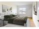 Spacious bedroom with large bed, hardwood floors, and modern art at 4675 Hickory Oak Dr, Brooksville, FL 34601