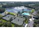 Aerial view of community pool, tennis courts, and parking at 4675 Hickory Oak Dr, Brooksville, FL 34601