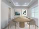 Elegant dining room with long wooden table and six light-beige chairs at 4675 Hickory Oak Dr, Brooksville, FL 34601