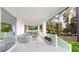 Covered patio with outdoor kitchen, seating area, and wooded backdrop at 4675 Hickory Oak Dr, Brooksville, FL 34601