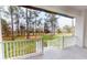 Inviting porch view overlooking lush green landscape and mature trees, providing a serene outdoor space at 4675 Hickory Oak Dr, Brooksville, FL 34601