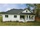 Beautiful rear exterior showcasing a bright white home with a covered porch and manicured lawn at 4675 Hickory Oak Dr, Brooksville, FL 34601
