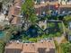 Aerial view of townhouses surrounding a central pond with lush landscaping at 5222 S Russell St # 25, Tampa, FL 33611