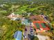 Amazing aerial view displaying the lush golf course, pool, tennis courts, and clubhouse at 8019 Feather Ct # C, Hudson, FL 34667