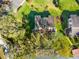 Aerial view of a well-maintained neighborhood with mature trees, landscaping, and gardens at 8019 Feather Ct # C, Hudson, FL 34667