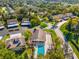 Lovely aerial view showing the neighborhood, pool, shuffleboard and verdant greenery at 8019 Feather Ct # C, Hudson, FL 34667
