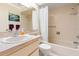 Tiled bathroom with a shower-tub combination, white shower curtain, and neutral decor at 8019 Feather Ct # C, Hudson, FL 34667