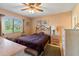 Cozy bedroom featuring a comfortable bed, window with natural light, and dresser at 8019 Feather Ct # C, Hudson, FL 34667