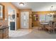 Inviting entryway leading to a dining area with a glass table and a glimpse of the kitchen at 8019 Feather Ct # C, Hudson, FL 34667