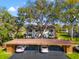 Charming home with covered parking, mature trees, landscaping, and a well-manicured lawn at 8019 Feather Ct # C, Hudson, FL 34667