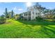 Beautiful two-story home exterior with lush lawn, screened balconies, and tropical landscaping at 8019 Feather Ct # C, Hudson, FL 34667