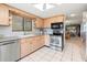 Bright kitchen with stainless steel appliances and light wood cabinets at 8019 Feather Ct # C, Hudson, FL 34667