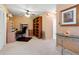 Carpeted office space with built-in shelving, desk, ceiling fan, and neutral wall color at 8019 Feather Ct # C, Hudson, FL 34667