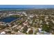 Expansive aerial view showcasing the property's location near a serene lake and the coast at 13632 Imperial Groves S Dr, Largo, FL 33774