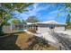 Landscaped backyard with pool and screened enclosure at 13632 Imperial Groves S Dr, Largo, FL 33774