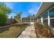 Stone pathway leads to a fenced backyard with pool at 13632 Imperial Groves S Dr, Largo, FL 33774