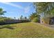 Spacious, well-maintained backyard with a lush lawn, privacy fence, and mature landscaping for outdoor enjoyment at 13632 Imperial Groves S Dr, Largo, FL 33774