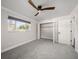 Bright bedroom with ceiling fan, window, and spacious closet at 13632 Imperial Groves S Dr, Largo, FL 33774