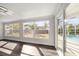Dining room with hardwood floors, large windows, and pool view at 13632 Imperial Groves S Dr, Largo, FL 33774