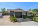 Contemporary home features a dark garage door and well-maintained landscaping at 13632 Imperial Groves S Dr, Largo, FL 33774
