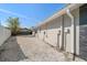 The side of the home features low-maintenance gravel landscaping, a modern color scheme, and seamless gutter system at 13632 Imperial Groves S Dr, Largo, FL 33774