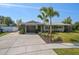 Charming single-story home featuring well-maintained landscaping, a two-car garage, and a modern, neutral color scheme at 13632 Imperial Groves S Dr, Largo, FL 33774