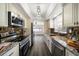Renovated kitchen with granite counters, stainless steel appliances, and dark wood floors at 13632 Imperial Groves S Dr, Largo, FL 33774