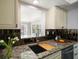 Kitchen features granite countertops, stylish backsplash, and modern sink at 13632 Imperial Groves S Dr, Largo, FL 33774