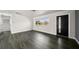 Living room with hardwood floors and modern front door at 13632 Imperial Groves S Dr, Largo, FL 33774