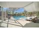 Inviting screened-in pool area with comfortable lounge chairs for relaxing and enjoying the sunny outdoors at 13632 Imperial Groves S Dr, Largo, FL 33774