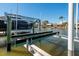 Elevated boat lift system with covered boat at 17726 Long Point Dr, Redington Shores, FL 33708