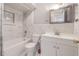 Updated bathroom with white vanity and marble tile at 1900 68Th N St # 301, St Petersburg, FL 33710