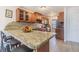 Kitchen with breakfast bar, granite counters, and wood cabinets at 1900 68Th N St # 301, St Petersburg, FL 33710