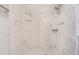 Clean shower with marble-style tile and built-in shelving at 1900 68Th N St # 301, St Petersburg, FL 33710