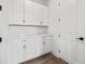 Pantry with built-in shelving, white cabinets, countertop and a door at 2021 Amelia Bay Pl, Valrico, FL 33596