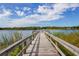 Picturesque wooden dock extending over calm lake waters at 2447 Ecuadorian Way # 11, Clearwater, FL 33763