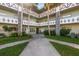 Exterior view of a two-story building with lush landscaping at 2447 Ecuadorian Way # 11, Clearwater, FL 33763