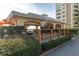 Covered outdoor BBQ area with grills and picnic tables at 4575 Cove Cir # 202, St Petersburg, FL 33708