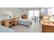 Comfortable bedroom with twin beds, built-in dresser and desk, and access to balcony at 4575 Cove Cir # 202, St Petersburg, FL 33708
