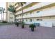 Attractive building exterior with palm trees and landscaping at 4575 Cove Cir # 202, St Petersburg, FL 33708