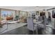 Bright dining area with glass table and chairs, offering a view into the living room at 4575 Cove Cir # 202, St Petersburg, FL 33708