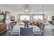 Modern dining area with glass table and chairs, reflecting light from large windows at 4575 Cove Cir # 202, St Petersburg, FL 33708